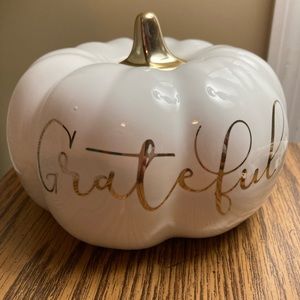 White “ Grateful “ pumpkin with gold lettering.